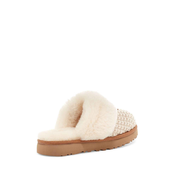 White slipper with brown sole on a white background