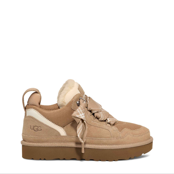 Beige sneaker with brown sole on a white background