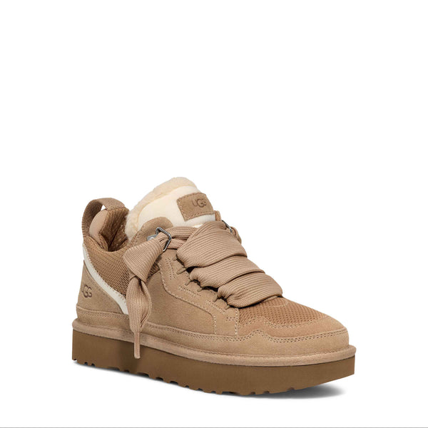 Beige sneaker with brown sole on a white background