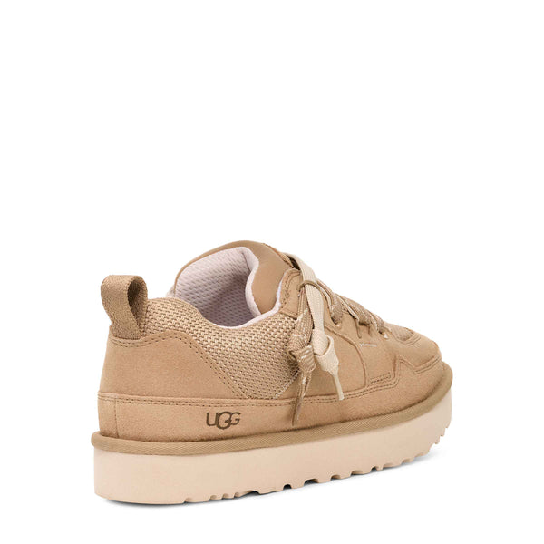 Beige sneaker with brand logo on a white background
