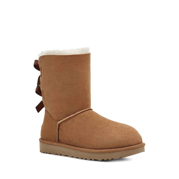 Tan boot with a bow on a white background