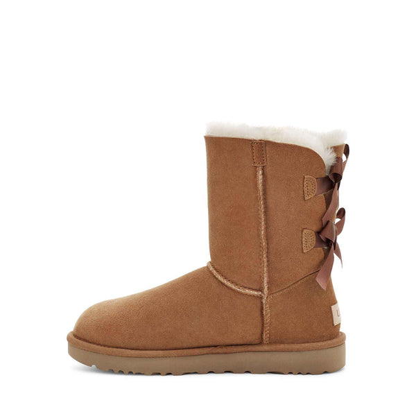 Brown winter boot with a bow on a white background