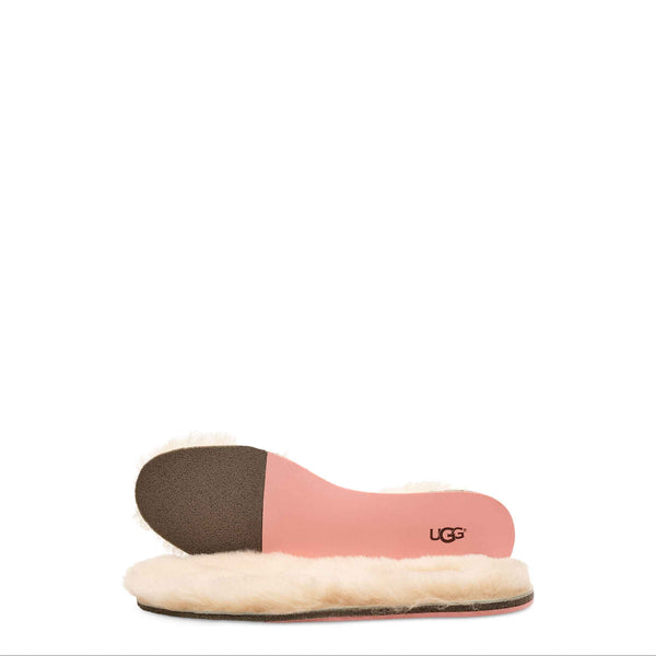 Pink and beige UGG slipper on a white background