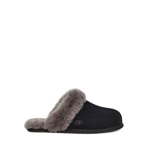 Side view of a single black UGG slipper with fluffy lining on a white background.