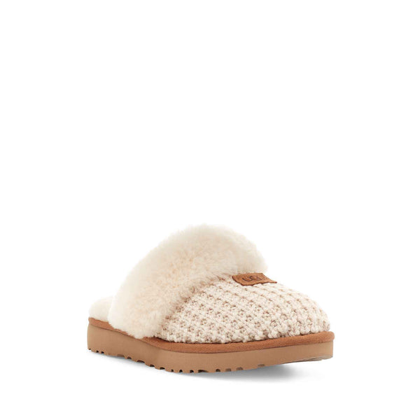 White slipper with brown sole on a white background