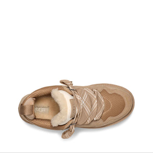 Brown UGG boot with shearling lining on a white background