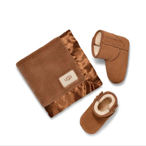 Brown baby booties and blanket with UGG logo on a white background