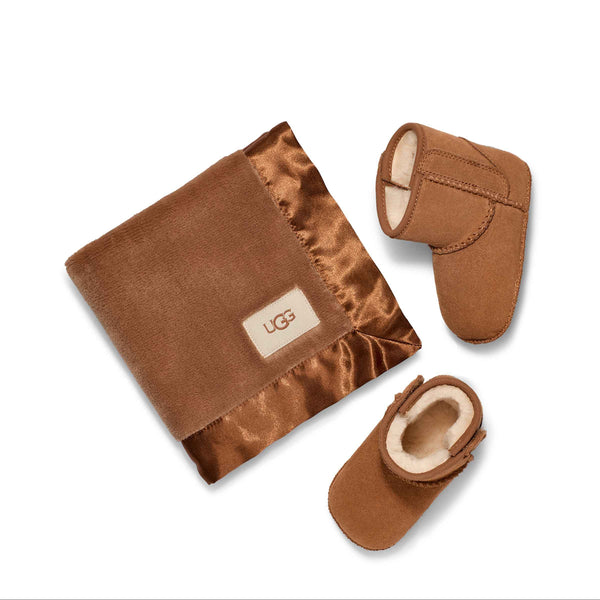 Brown baby booties and blanket with UGG logo on a white background
