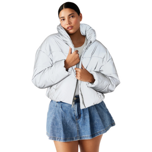 Person in white puffer jacket and blue denim skirt, isolated on white background.