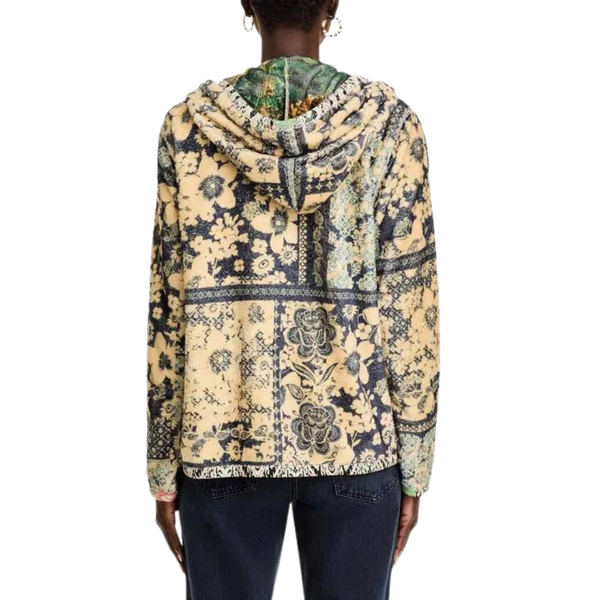 Person from behind wearing a patterned hooded sweatshirt with a floral design.