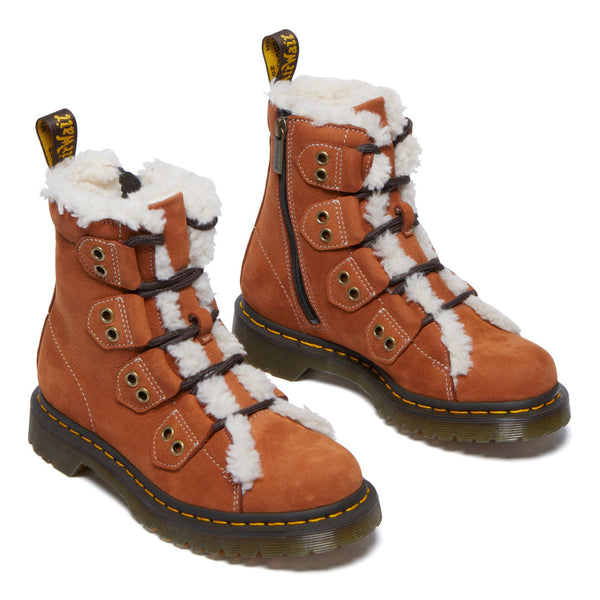 Pair of brown winter boots with white fur lining and yellow stitch details.