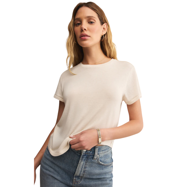 Woman wearing a white t-shirt and blue jeans on a white background