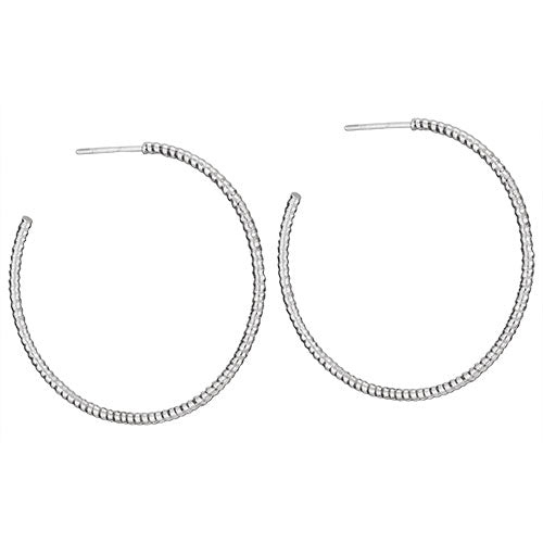 A pair of silver hoop earrings on a white background.