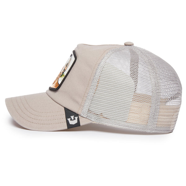 Side view of a beige trucker hat with embroidered deer and the word "trophy" patch on the front.